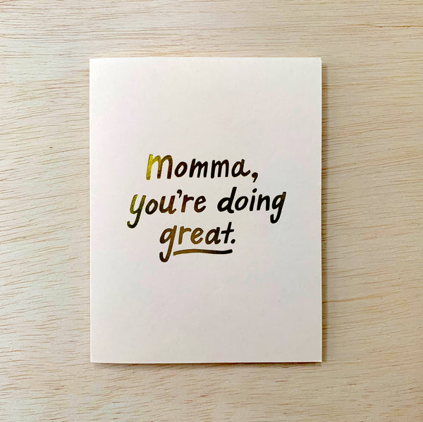 White card with golden text reading "Momma, you're doing great."